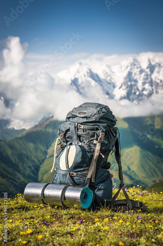 Tourist backpack and sleeping pad on a background of mountains © andriano_cz