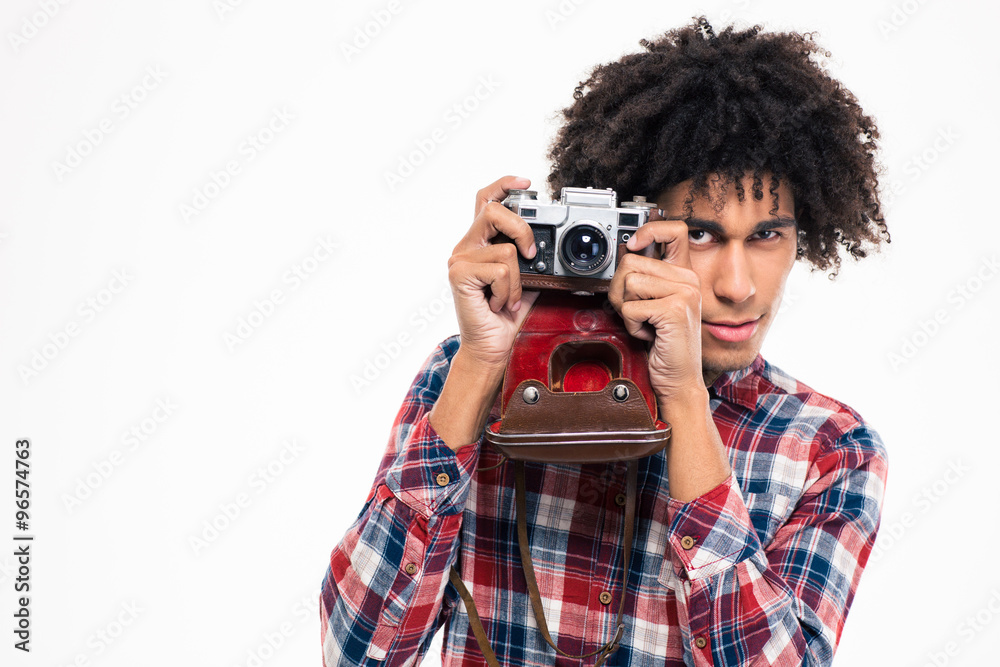Afro american man making photo on retro camera