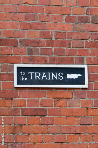 To The Trains sign on wall at Railway Station