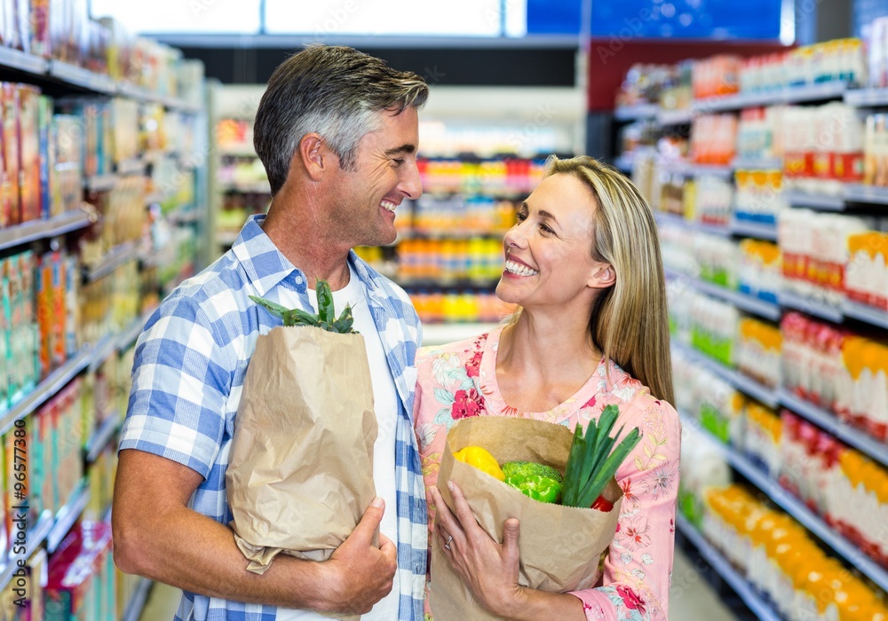 Smiling couple with grocery bags