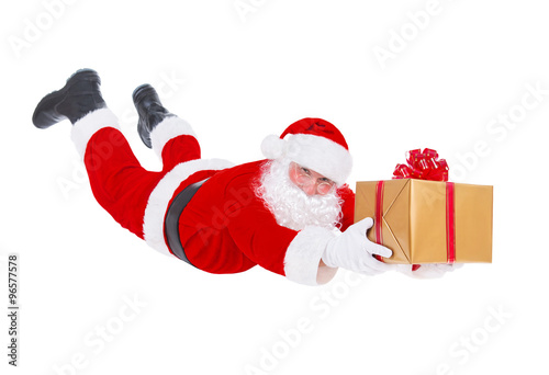 Santa Claus flying with Christmas gift isolated on white backgro