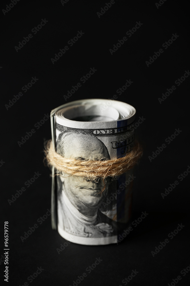 Dollars roll on black background Dollars roll on black background