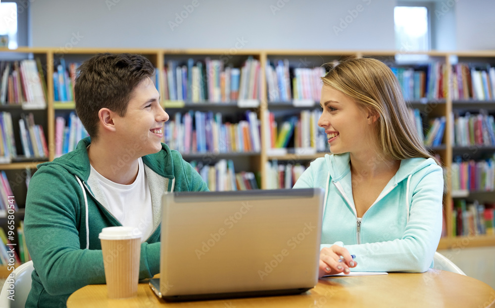happy students with laptop in library happy students with laptop in library