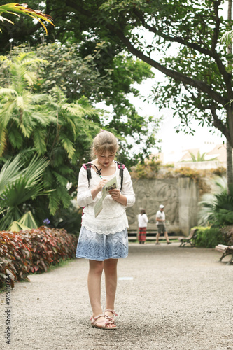 Little girl 10 year old with a map of walks in the botanic park