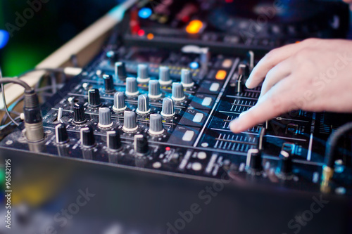 DJ mixing music on console at the night club
