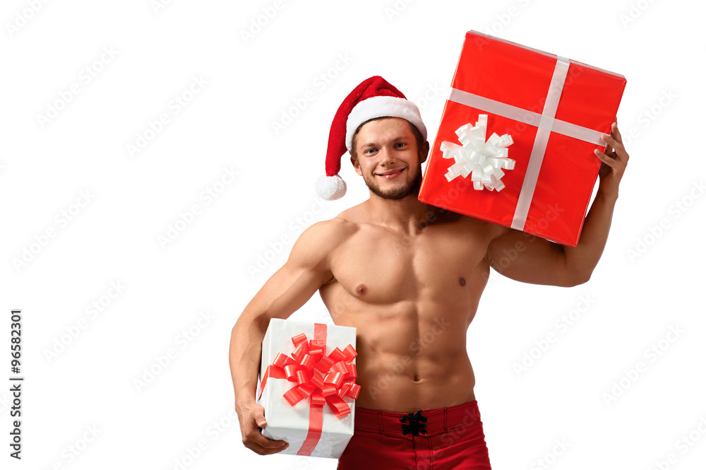 He has got something special. Horizontal shot of a sexy Santa Claus with toned body holding two presents isolated on white He has got something special. Horizontal shot of a sexy Santa Claus with toned body holding two presents isolated on white