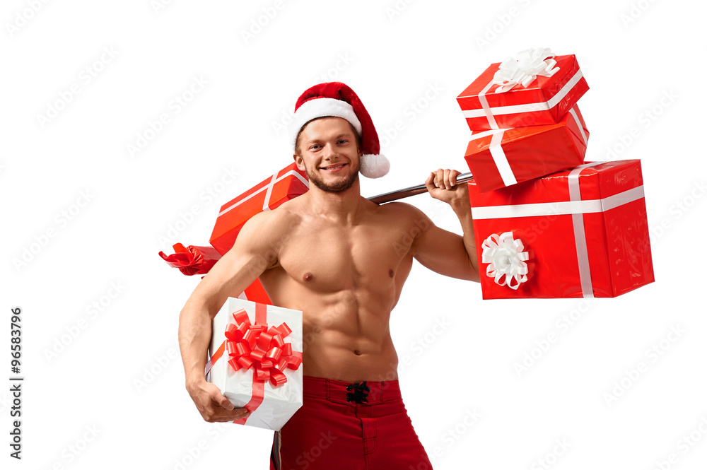 I want you to have this! Horizontal shot of a young fitness man wearing Christmas hat with numerous gift boxes smiling cheerfully I want you to have this! Horizontal shot of a young fitness man wearing Christmas hat with numerous gift boxes smiling cheerfully