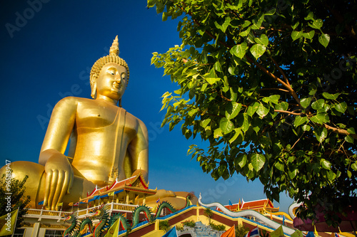 The largest golden Buddha with blue sky as a backdrop.
