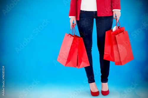 Midsection of woman holding shopping bags