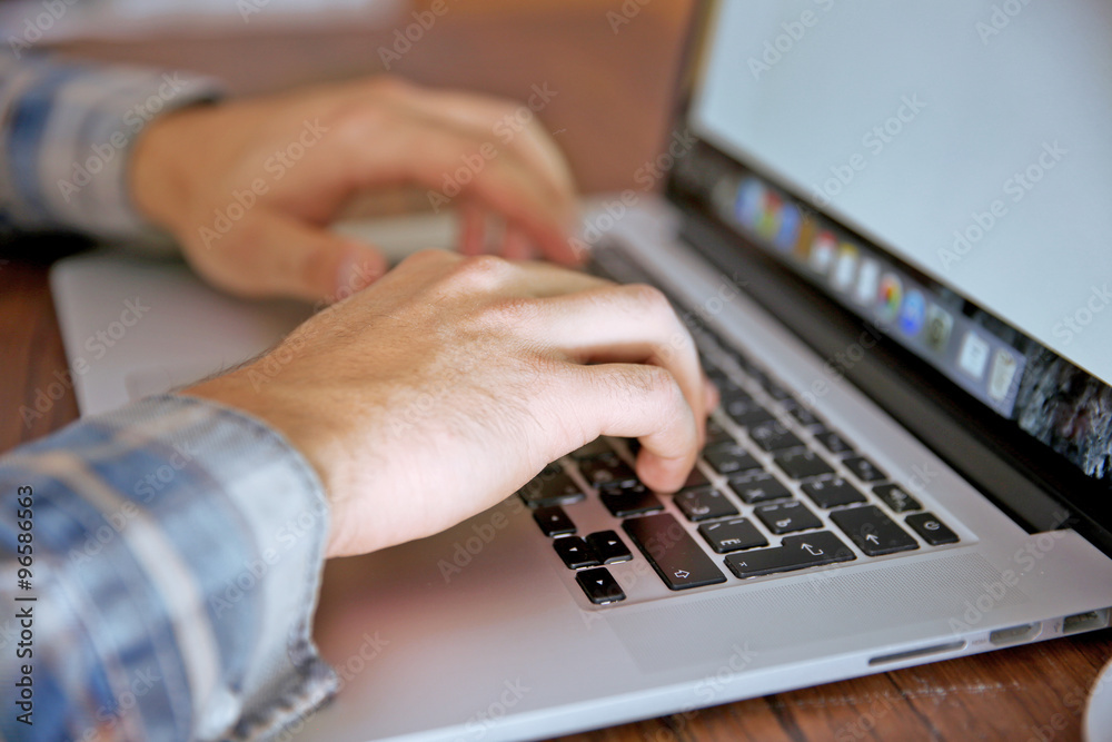 Young man using his laptop, close up Young man using his laptop, close up