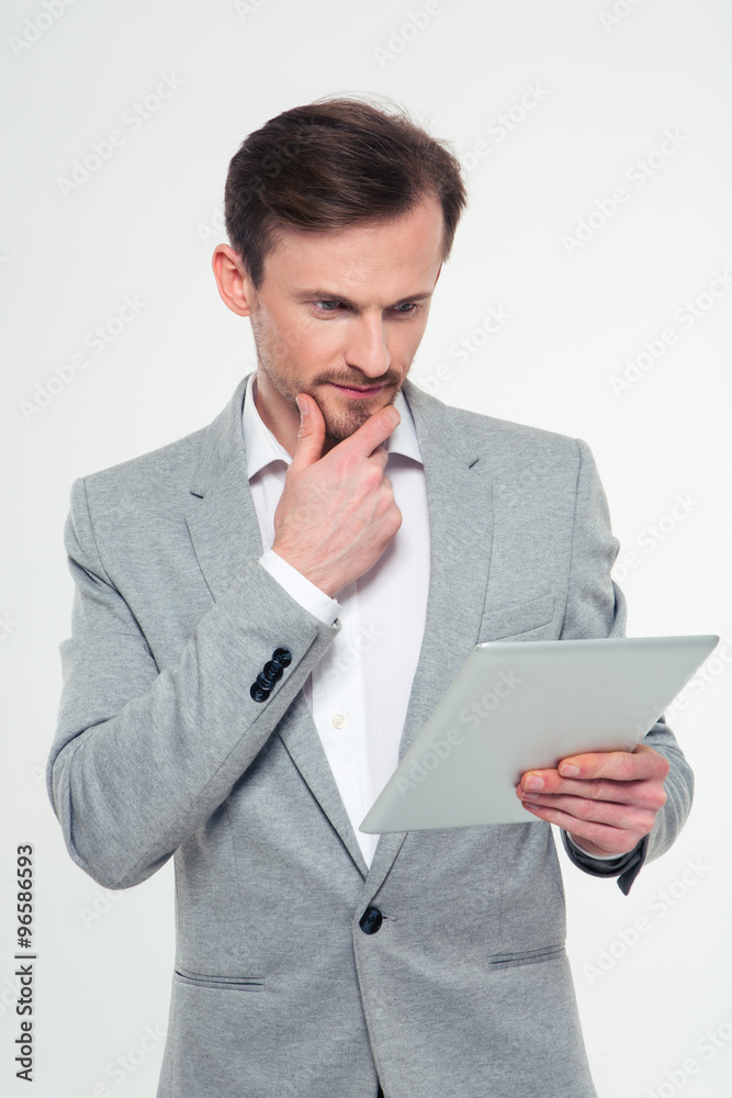 Thoughtful businessman using tablet computer Thoughtful businessman using tablet computer
