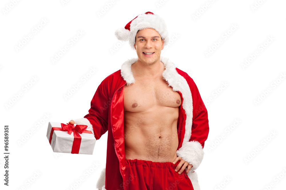 Handsome man in Santa costume holding a present Handsome man in Santa costume holding a present