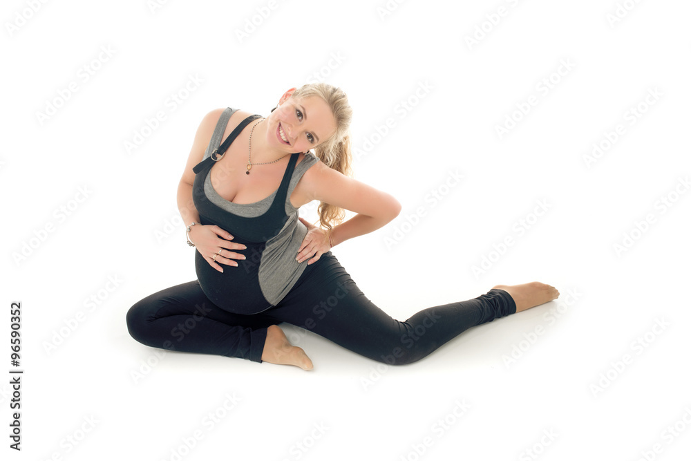 Pregnant woman doing sport exercises in yoga style Pregnant woman doing sport exercises in yoga style