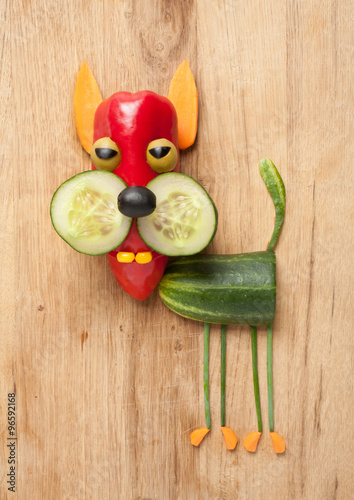 Funny vegetable cat on wooden background