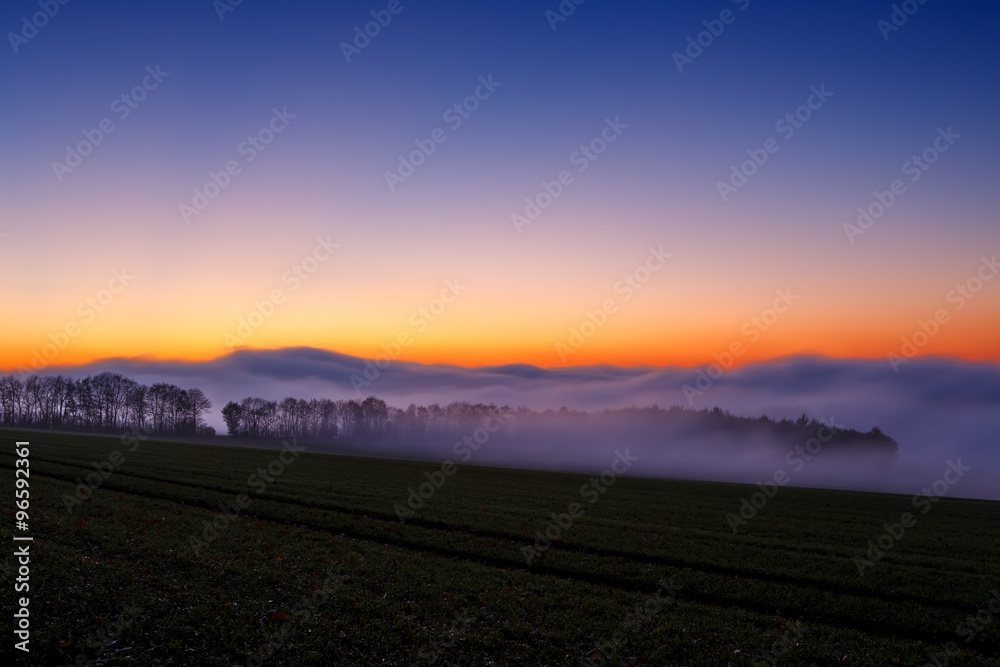Obraz premium Foggy Sunset in Wintertime