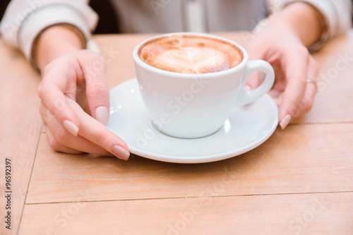 Female hands holding coffee