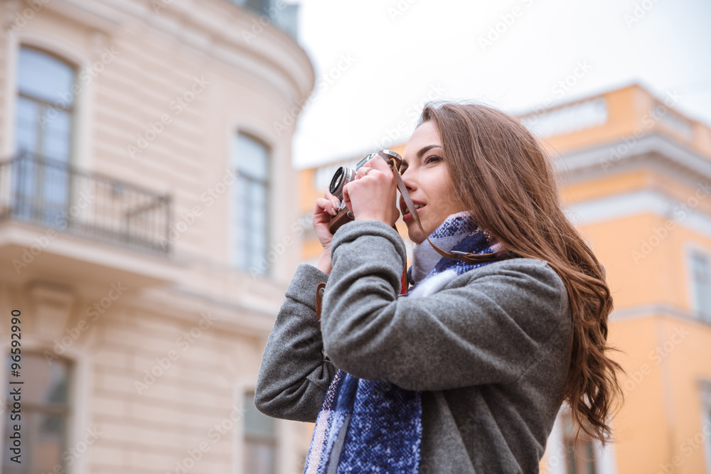 Woman making photo on retro camera