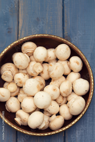 mushrooms in bowl on blue background