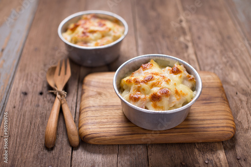 The cheesy Au Gratin with with  wooden spoon