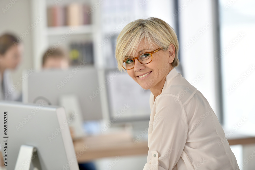 Senior businesswoman standing in office Senior businesswoman standing in office
