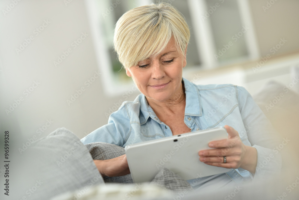 Senior woman websurfing on digital tablet Senior woman websurfing on digital tablet