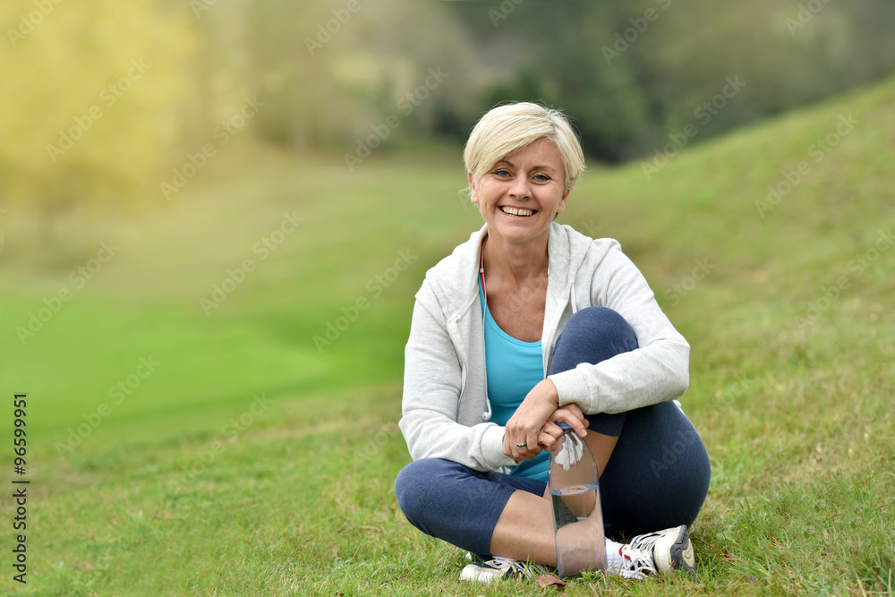Fototapeta premium Senior woman relaxing outside, sit in park