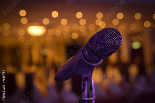 Wireless microphone stand on the stage venue with blur bokeh bac