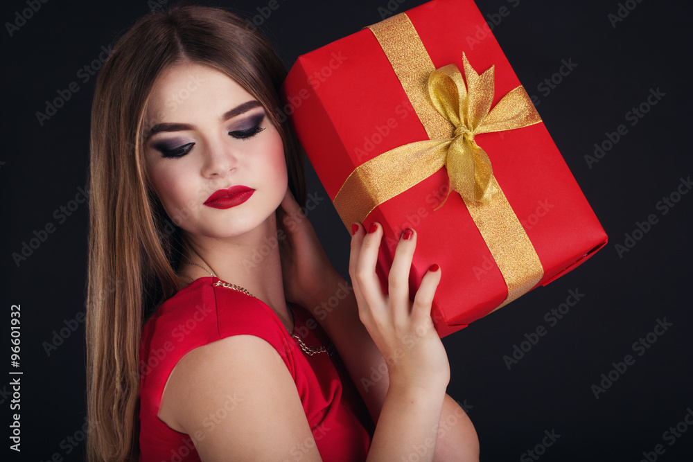Pretty girl is holding gift box, Christmas time Pretty girl is holding gift box, Christmas time