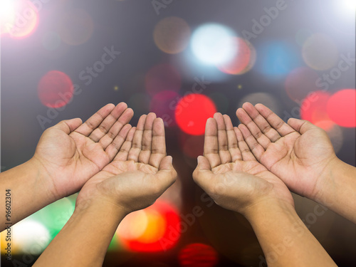 Human open empty hands with palms up over blurred bokeh backgrou photo