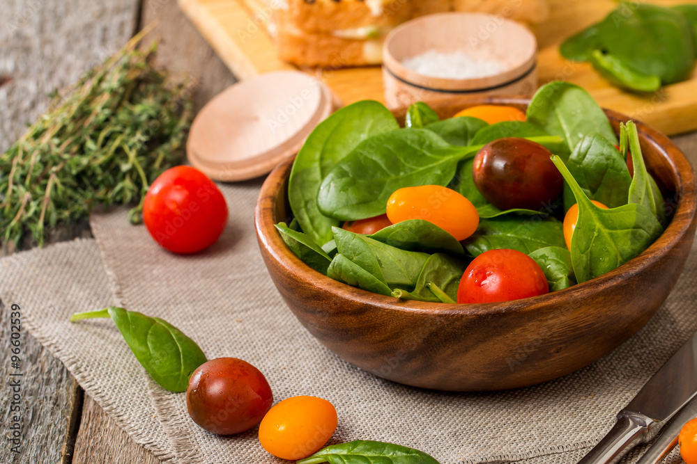Salad made with baby spinach and cherry tomatoes Salad made with baby spinach and cherry tomatoes