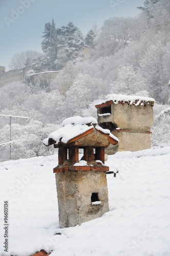 Chimneys covered with snow winter landscape