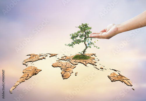 Tableau sur toile Human hands drop water on dry world map engender Moisturizing ma