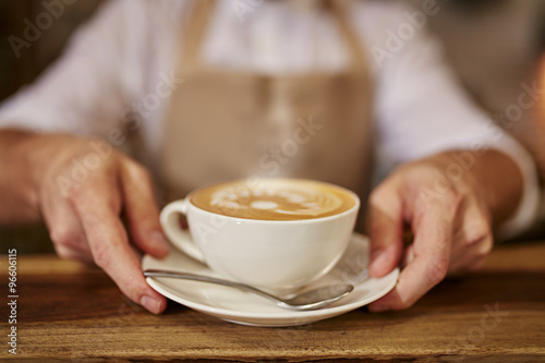 Barista serving coffee