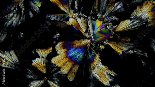 Microscopic shot: Sugar crystals in polarized light with color changes at different wavelengths.