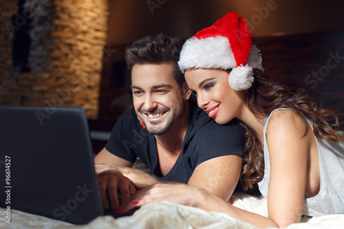 Young couple searching for christmas presents online
