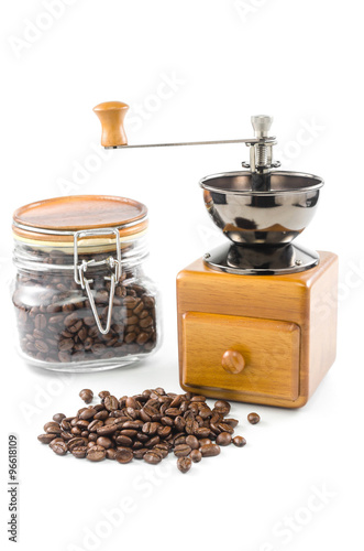 roasted coffee beans with coffee grinder and glass bottle
