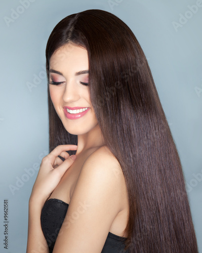 Young happy smiling beautiful brunette woman with healthy long brown hair. Beauty haircare and hairdressing concept