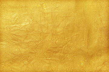 Shiny yellow leaf gold foil texture background