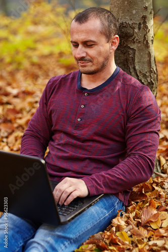 Businessman with laptop working outdoor