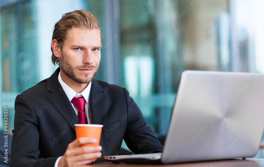 Businessman reading his digital tablet during breakfast Businessman reading his digital tablet during breakfast
