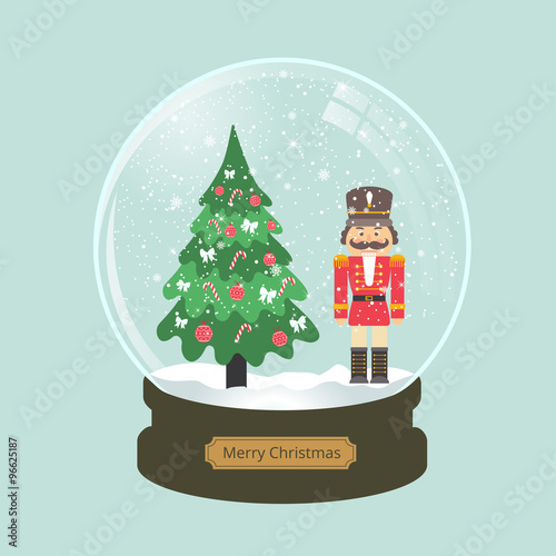 christmas snow globe with nutcracker and fir-tree