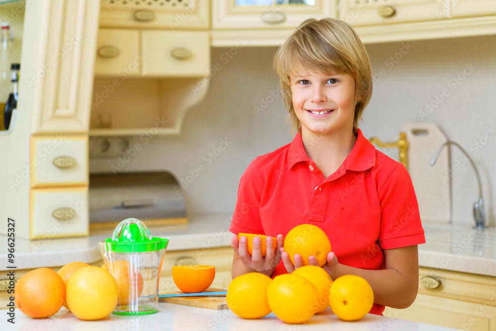 Funny teenager with citrus. Boy holding fruit oranges