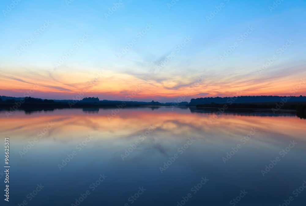 Sunset landscape with blue sky at the calm lake