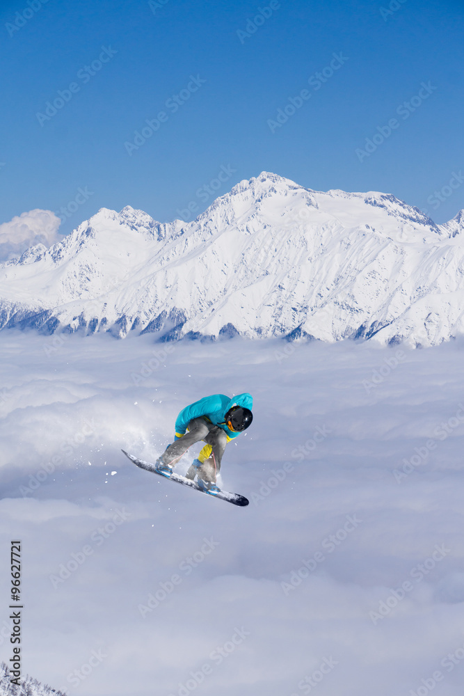 Flying snowboarder on mountains