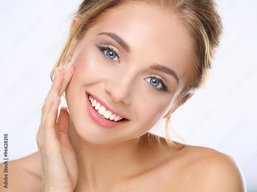 Young woman touching her face isolated on white background Young woman touching her face isolated on white background