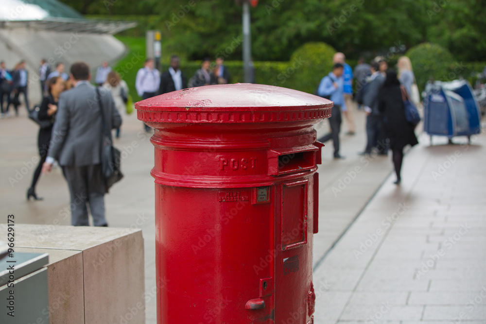 LONDON, UK - SEPTEMBER 14, 2015: Royal mail red post box in Canary Wharf LONDON, UK - SEPTEMBER 14, 2015: Royal mail red post box in Canary Wharf
