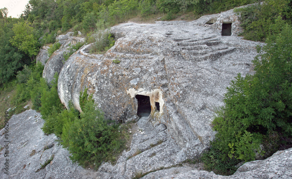 Ancient caves in which lived the first people, rocks overgrown w