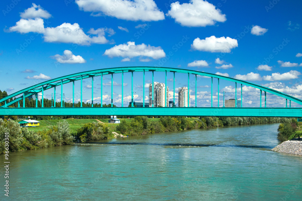 Green Railway bridge over Sava river in Zagreb and modern skyline