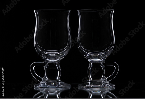 Two glasses on a black background