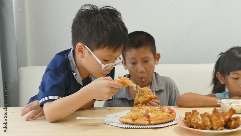 Asian children having lunch together at home
Asian children having lunch together at home